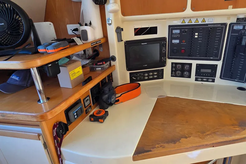 Slide: The Image of Navigation station of a 2004 Leopard 47 catamaran with control panels and equipment. - 46