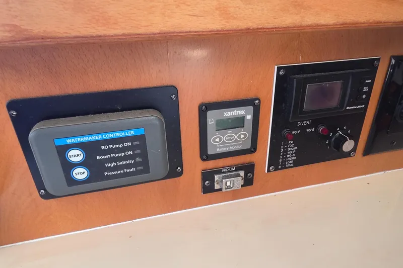 Slide: The Image of Control panel of a 2004 Leopard 47 yacht with watermaker and battery monitor. - 48