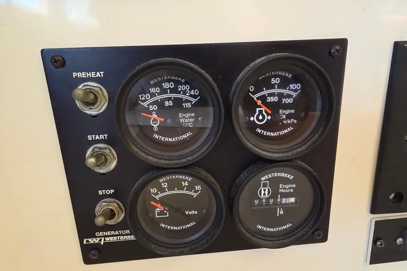 Slide: The Image of Control panel of a 2004 Leopard 47 with engine gauges and switches. - 49