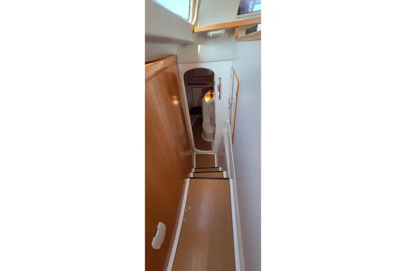 Slide: The Image of Stairway inside 2004 Leopard 47 yacht, featuring wooden steps and sleek interior design. - 50