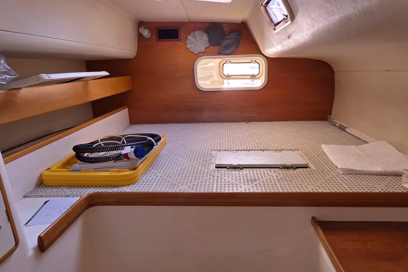 Slide: The Image of Interior cabin of a 2004 Leopard 47 catamaran, featuring a cozy sleeping area. - 51