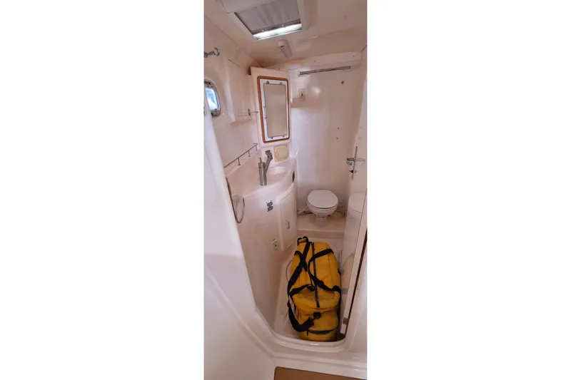 Slide: The Image of Bathroom interior of 2004 Leopard 47 yacht with yellow duffel bag. - 52