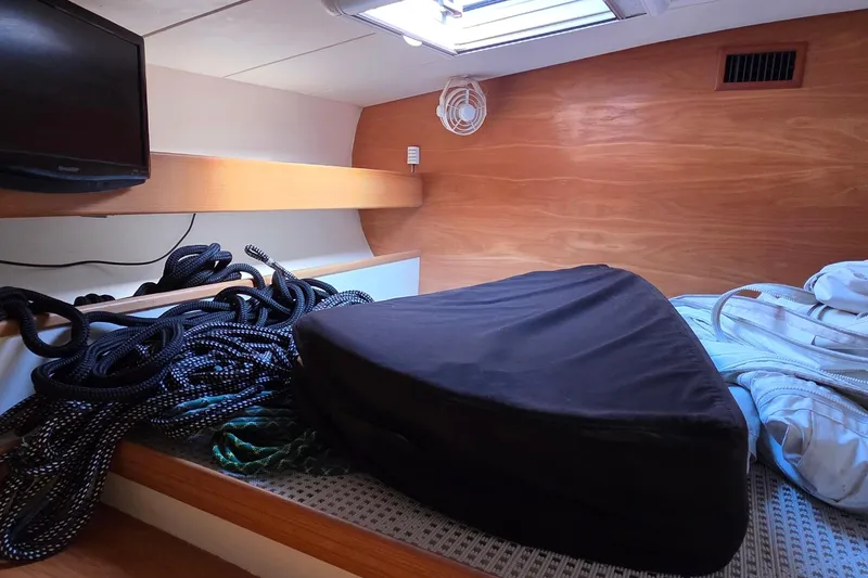 Slide: The Image of Interior of a 2004 Leopard 47 yacht cabin with ropes and a TV. - 55