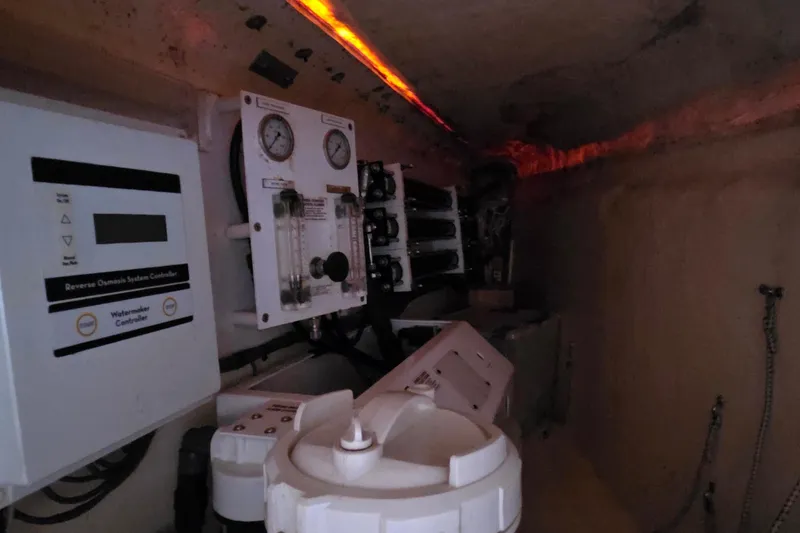 Slide: The Image of Engine room of a 2004 Leopard 47 yacht with control panels and gauges. - 57