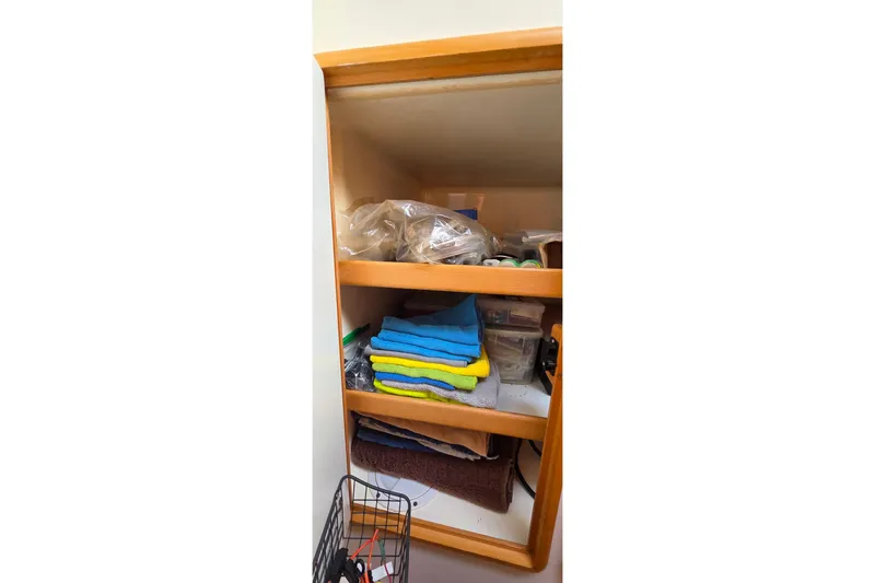 Slide: The Image of Storage shelves with towels and supplies on a Leopard 47, 2004 model. - 59