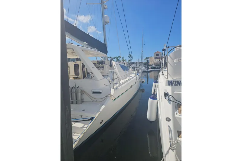 Slide: The Image of 2004 Leopard 47 yacht docked in a sunny marina. - 6