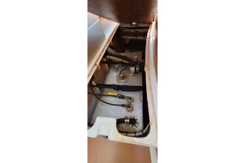 Slide: The Image of Engine compartment of a 2004 Leopard 47 catamaran, showing mechanical components and wiring. - 60