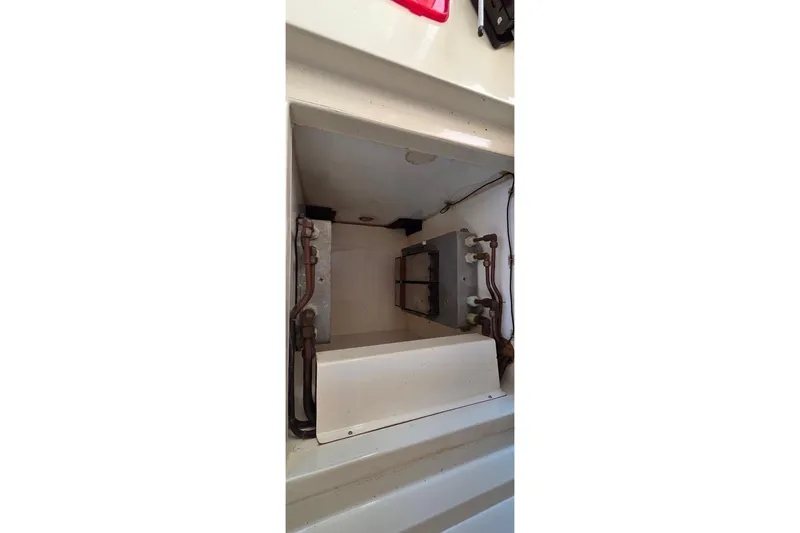 Slide: The Image of Interior view of a 2004 Leopard 47 yacht compartment with visible wiring and components. - 61