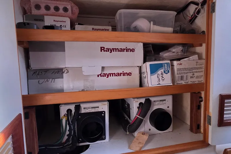 Slide: The Image of Storage cabinet with Raymarine equipment and electrical components on a 2004 Leopard 47 yacht. - 62