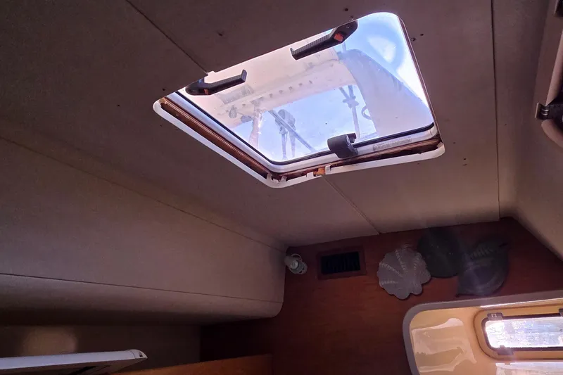 Slide: The Image of Interior view of a 2004 Leopard 47 yacht with an open ceiling hatch. - 63