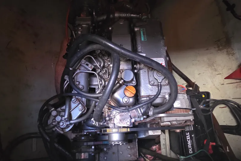 Slide: The Image of Engine compartment of a 2004 Leopard 47 yacht, showcasing mechanical components and wiring. - 64