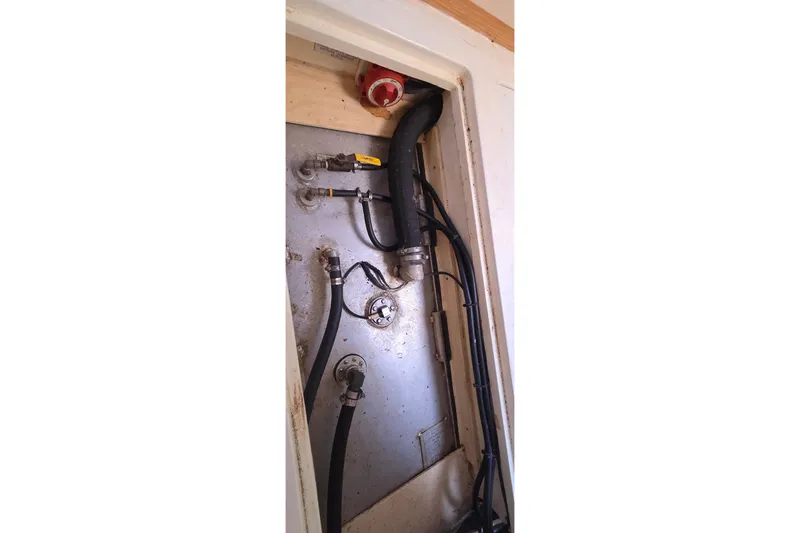 Slide: The Image of Engine compartment of a 2004 Leopard 47 yacht, showing hoses and fittings. - 68