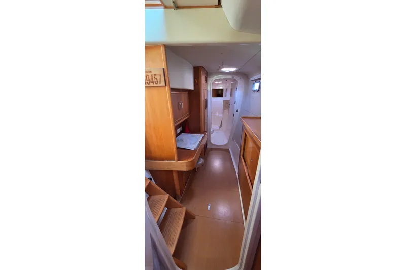 Slide: The Image of Interior of 2004 Leopard 47 yacht, featuring wooden cabinetry and compact design. - 70