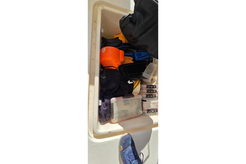 Slide: The Image of Storage compartment on a 2004 Leopard 47 yacht, filled with various tools and equipment. - 76