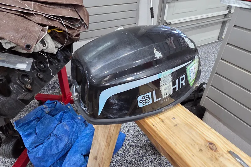 Slide: The Image of Outboard motor cover on wooden stand, garage setting, Leopard 47, 2004 model. - 81