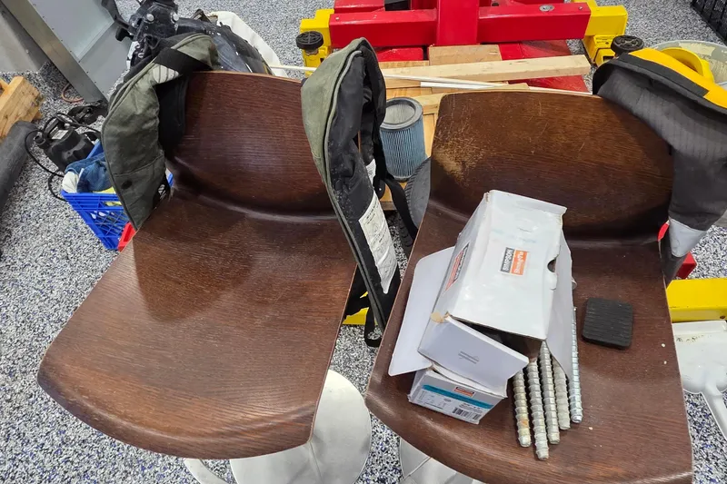 Slide: The Image of Two wooden chairs with boxes and items in a workshop setting. - 82