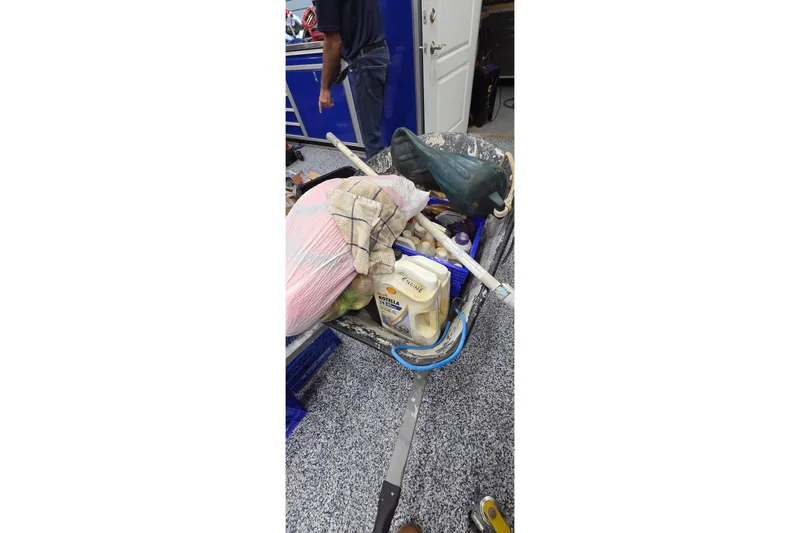 Slide: The Image of A cluttered workspace with tools, containers, and a person in a garage setting. - 89