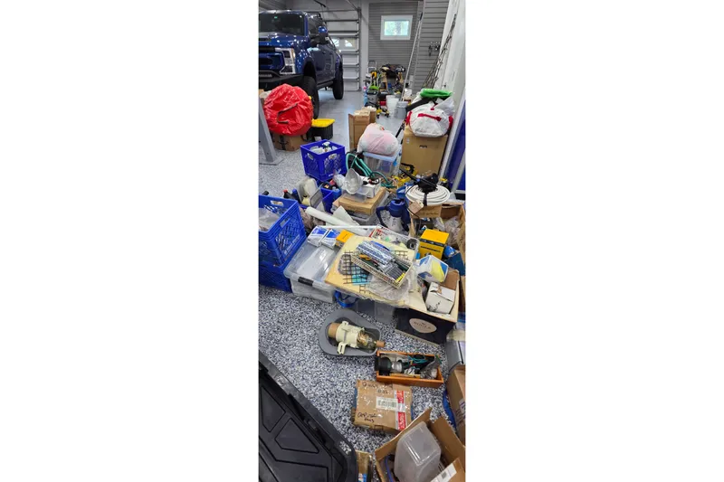 Slide: The Image of Cluttered garage with assorted tools and boxes, featuring a 2004 Leopard 47 model. - 93