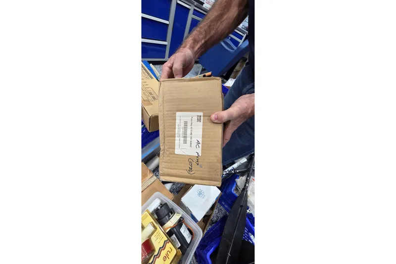 Slide: The Image of Person holding a cardboard box with a label, surrounded by various items. - 95