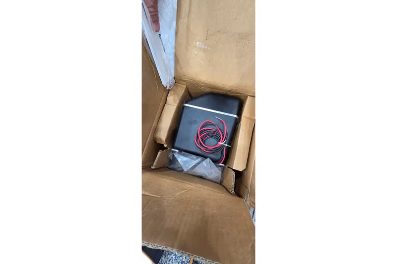 Slide: The Image of Cardboard box containing electronic device with red wires, Leopard 47 model, 2004. - 97