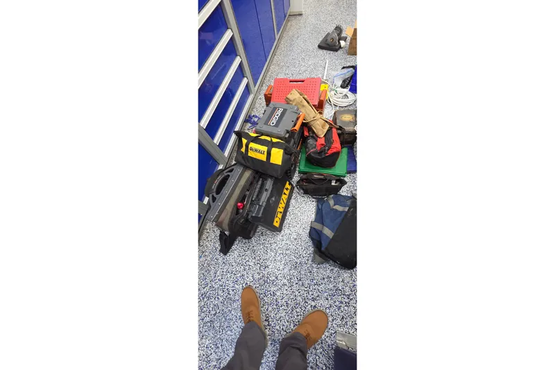 Slide: The Image of Tools and equipment on speckled floor near blue cabinets, Leopard 47, 2004. - 99