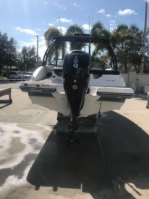Slide: The Image of 2022 Sea Ray SPX 190 boat with outboard motor, parked outdoors. - 10