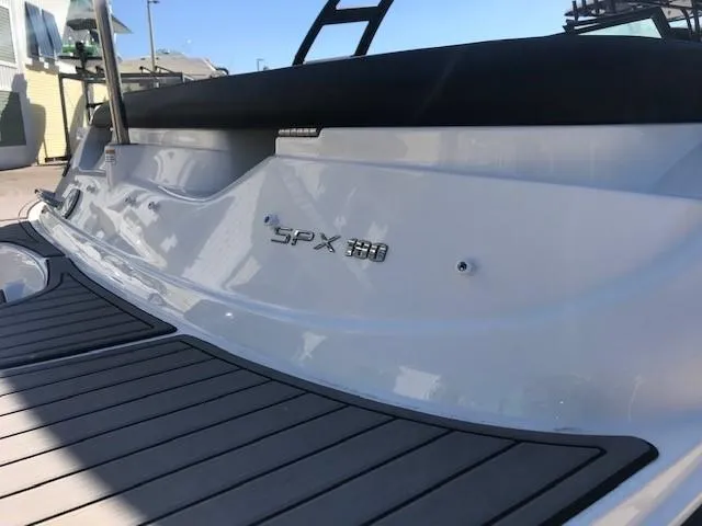Slide: The Image of 2022 Sea Ray SPX 190 OB boat, rear view, sleek design, docked. - 14