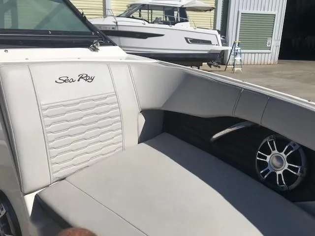 Slide: The Image of 2022 Sea Ray SPX 190 OB boat interior with white seating and logo. - 20