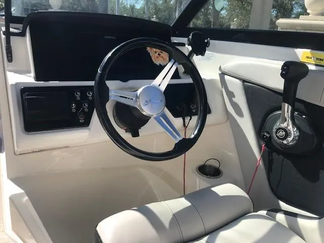 Slide: The Image of 2022 Sea Ray SPX 190 OB boat cockpit with steering wheel and controls. - 26