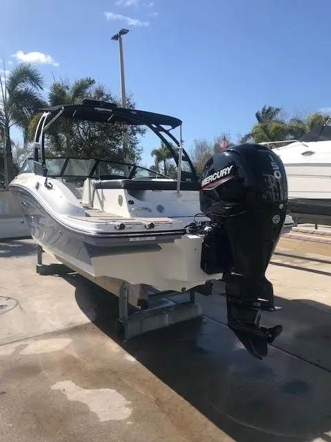 Slide: The Image of 2022 Sea Ray SPX 190 boat with Mercury outboard motor, docked under clear skies. - 9