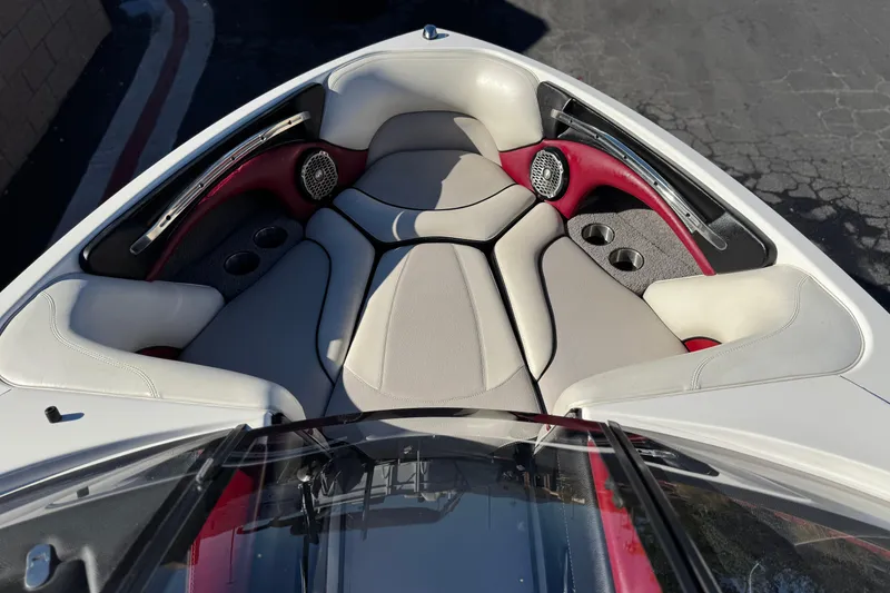 Slide: The Image of 2012 Malibu Wakesetter 21 VLX boat interior with cushioned seating and cup holders. - 13