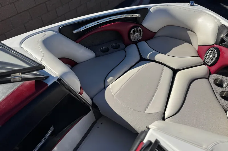 Slide: The Image of 2012 Malibu Wakesetter 21 VLX boat interior with cushioned seating and speakers. - 14