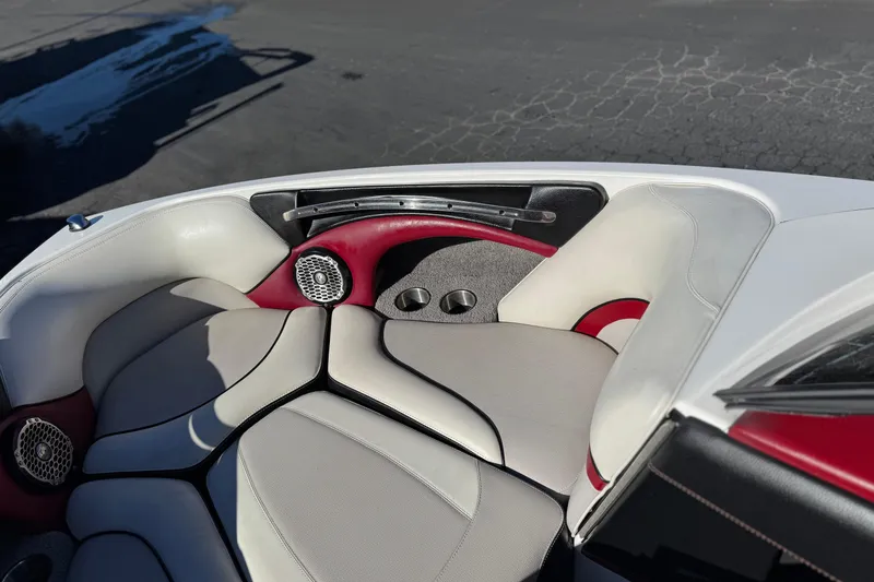 Slide: The Image of 2012 Malibu Wakesetter 21 VLX boat interior with red and white seating, cup holders, and speakers. - 15