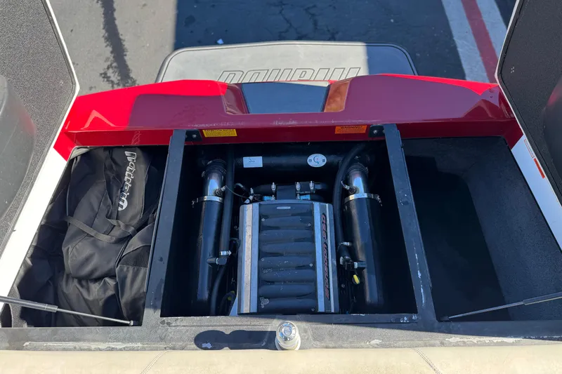 Slide: The Image of 2012 Malibu Wakesetter 21 VLX engine compartment with storage and equipment. - 19