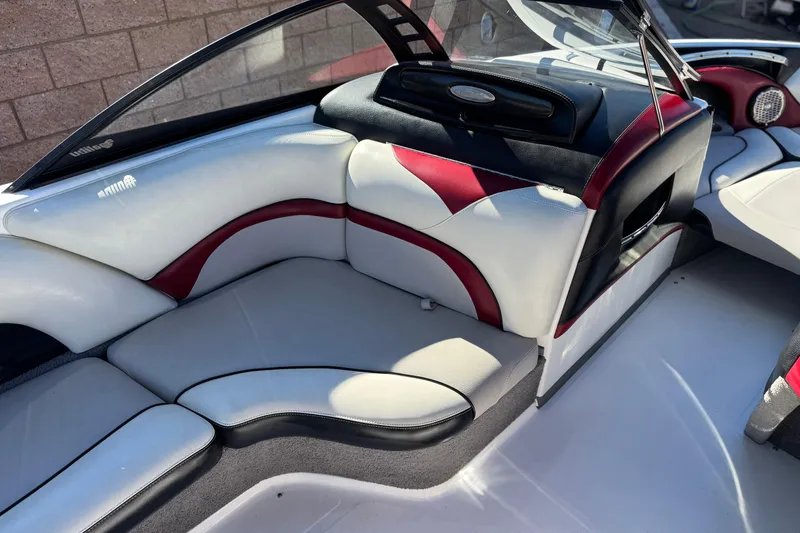 Slide: The Image of 2012 Malibu Wakesetter 21 VLX interior with white and red seating, sleek design. - 22