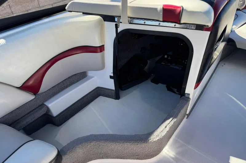 Slide: The Image of Interior of a 2012 Malibu Wakesetter 21 VLX boat, featuring seating and storage area. - 23
