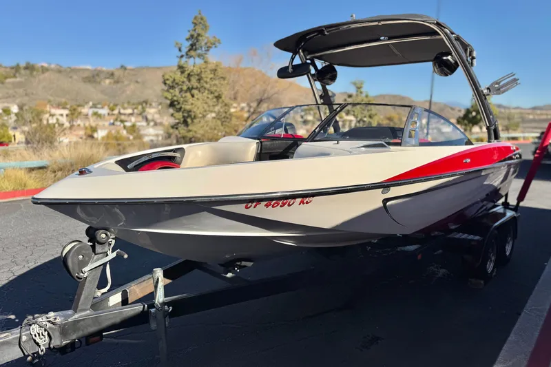 Slide: The Image of 2012 Malibu Wakesetter 21 VLX boat on trailer, parked outdoors. - 3