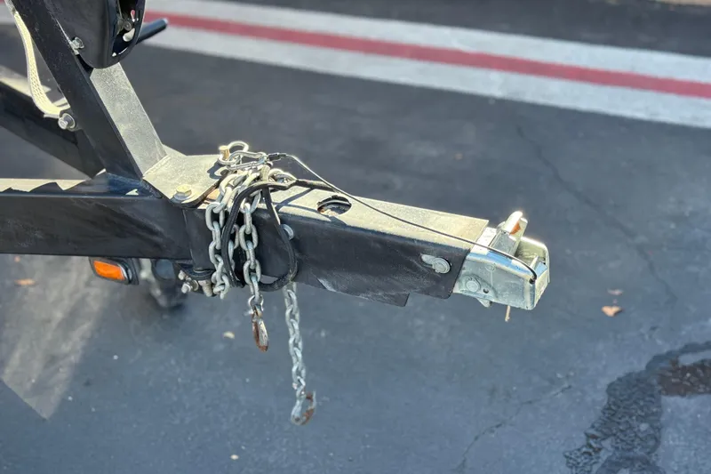 Slide: The Image of Trailer hitch of a 2012 Malibu Wakesetter 21 VLX with safety chains attached. - 31