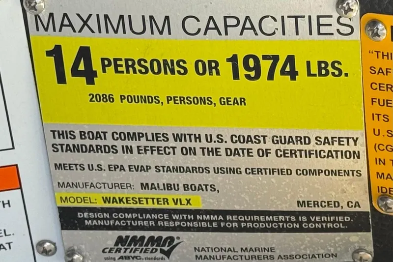 Slide: The Image of 2012 Malibu Wakesetter 21 VLX capacity plate, 14 persons or 1974 lbs, safety compliance. - 32