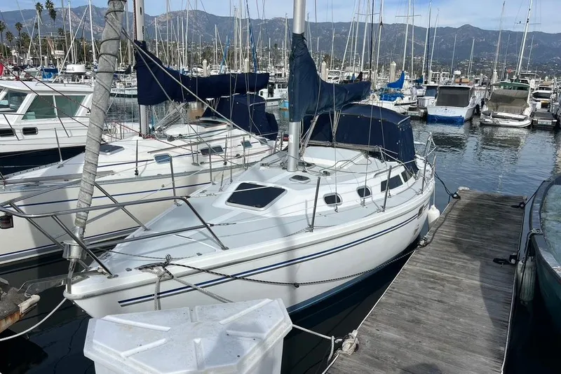 The Image of Catalina 30 sailboat, 2003 model, docked in a marina with mountains in the background. - 1