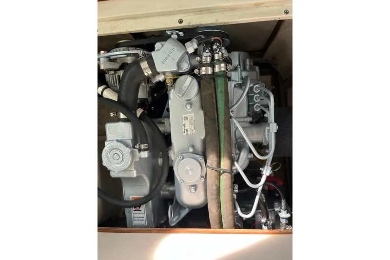 Slide: The Image of Engine of a 2003 Catalina 30 sailboat, showcasing mechanical components and hoses. - 10