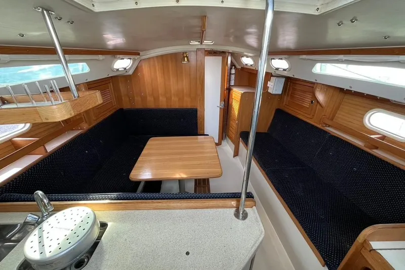 Slide: The Image of Interior of a 2003 Catalina 30 sailboat with wooden finishes and seating area. - 3