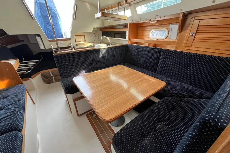 Slide: The Image of Interior of a 2003 Catalina 30 sailboat with cozy seating and wooden table. - 6
