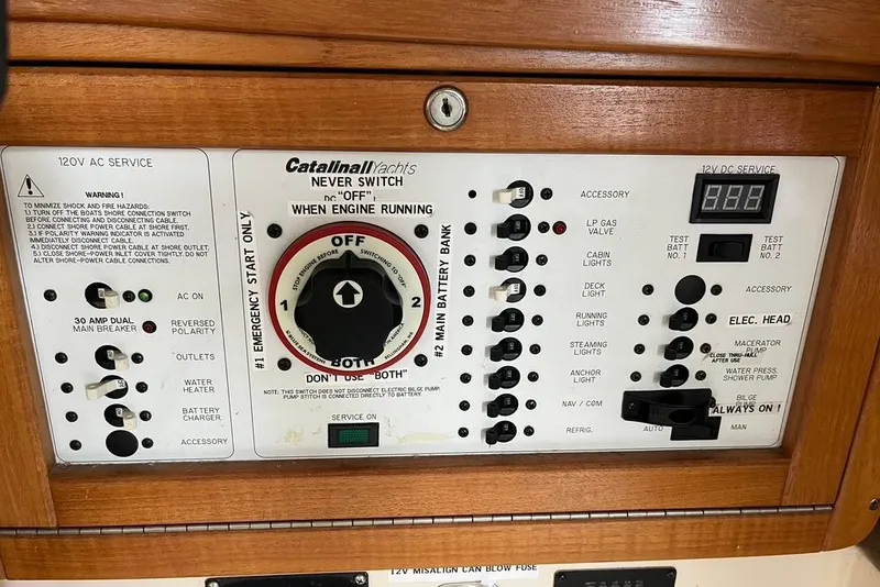 Slide: The Image of Control panel of a 2003 Catalina 30 yacht with various switches and indicators. - 8