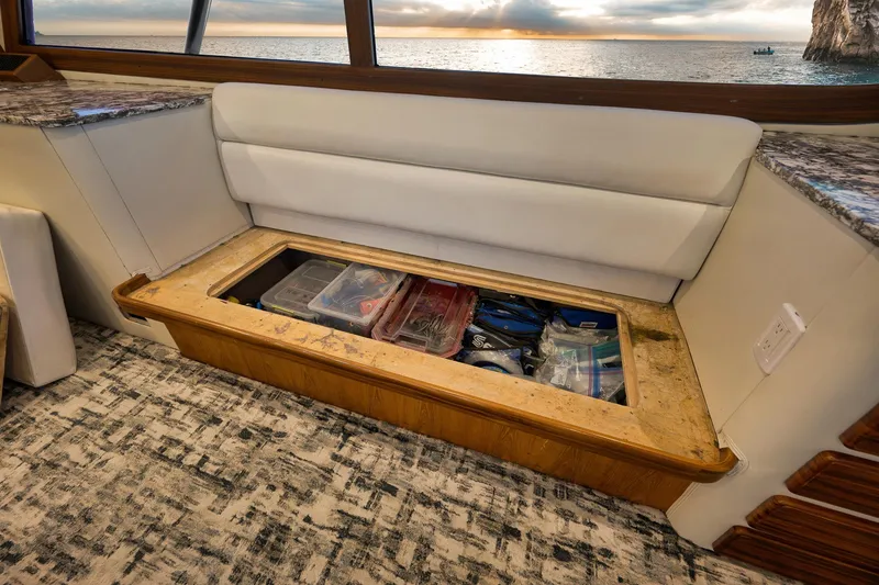 Slide: The Image of Interior of 2004 Guthrie 60 Custom Carolina with under-seat storage and ocean view. - 11