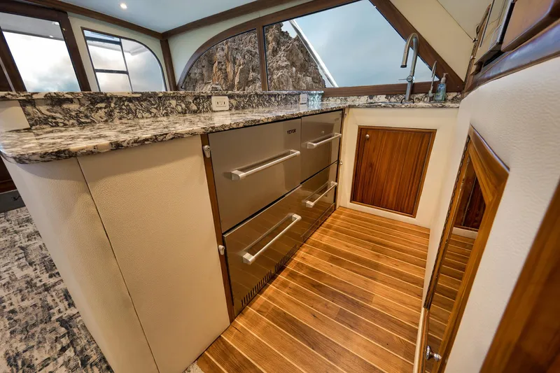 Slide: The Image of Luxurious kitchen interior of 2004 Guthrie 60 Custom Carolina yacht with wood flooring and granite countertops. - 21