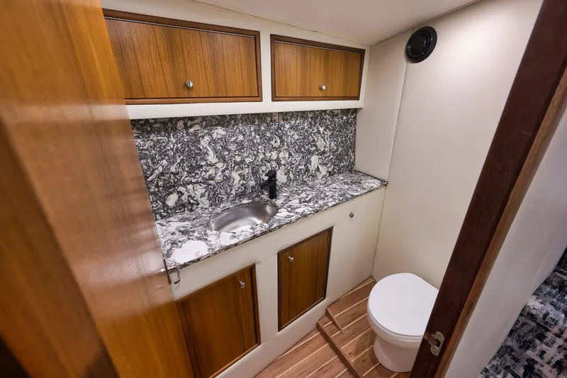 Slide: The Image of Luxurious 2004 Guthrie 60 Custom Carolina yacht bathroom with marble countertop and wooden cabinets. - 28