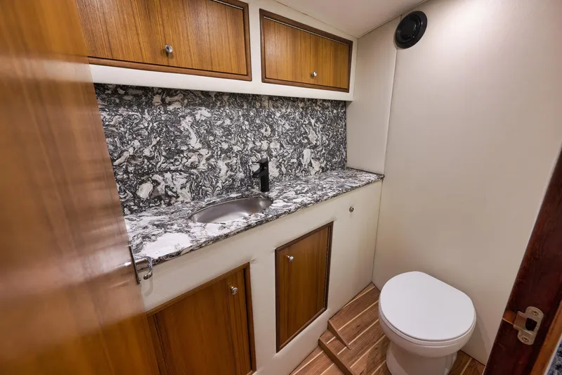 Slide: The Image of Luxurious bathroom in 2004 Guthrie 60 Custom Carolina yacht with marble countertop and wooden cabinets. - 29