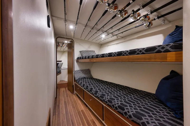 Slide: The Image of 2004 Guthrie 60 Custom Carolina yacht interior with bunk beds and fishing rods. - 31