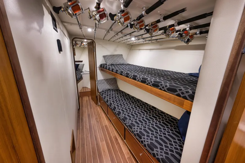 Slide: The Image of 2004 Guthrie 60 Custom Carolina yacht cabin with bunk beds and fishing rods. - 32